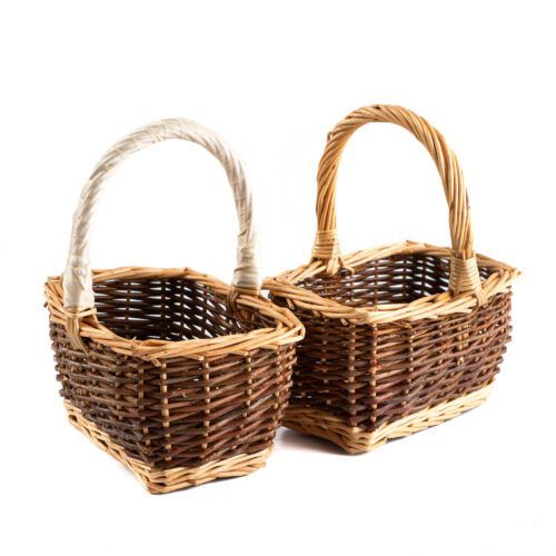 Two small wicker baskets. The main body of the basket is dark and the edges and handle a lighter wicker colour. One basket has cream ribbon wrapped around the handle.